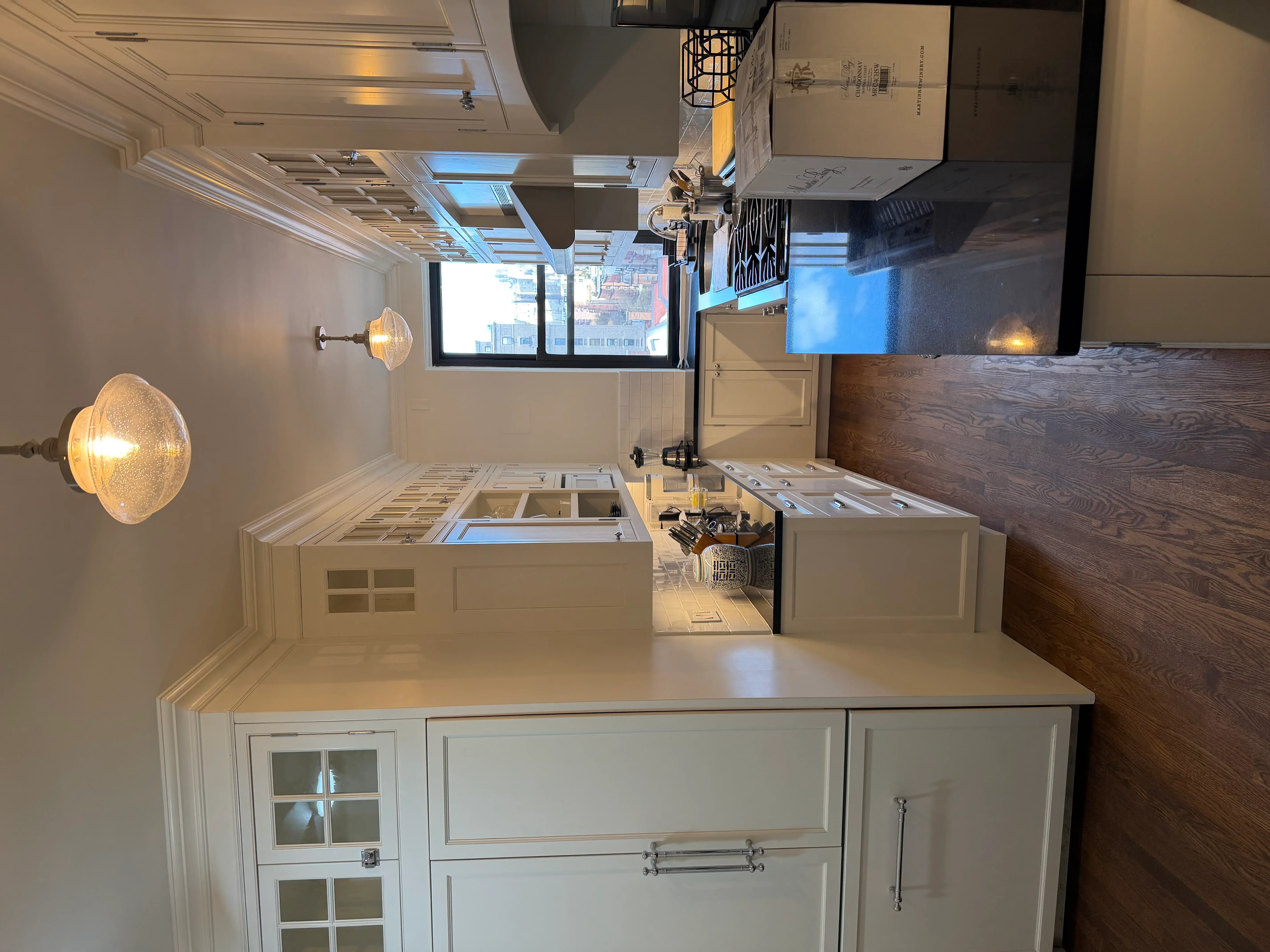 Modern kitchen with cream cabinetry, quartz counters, and recessed lighting