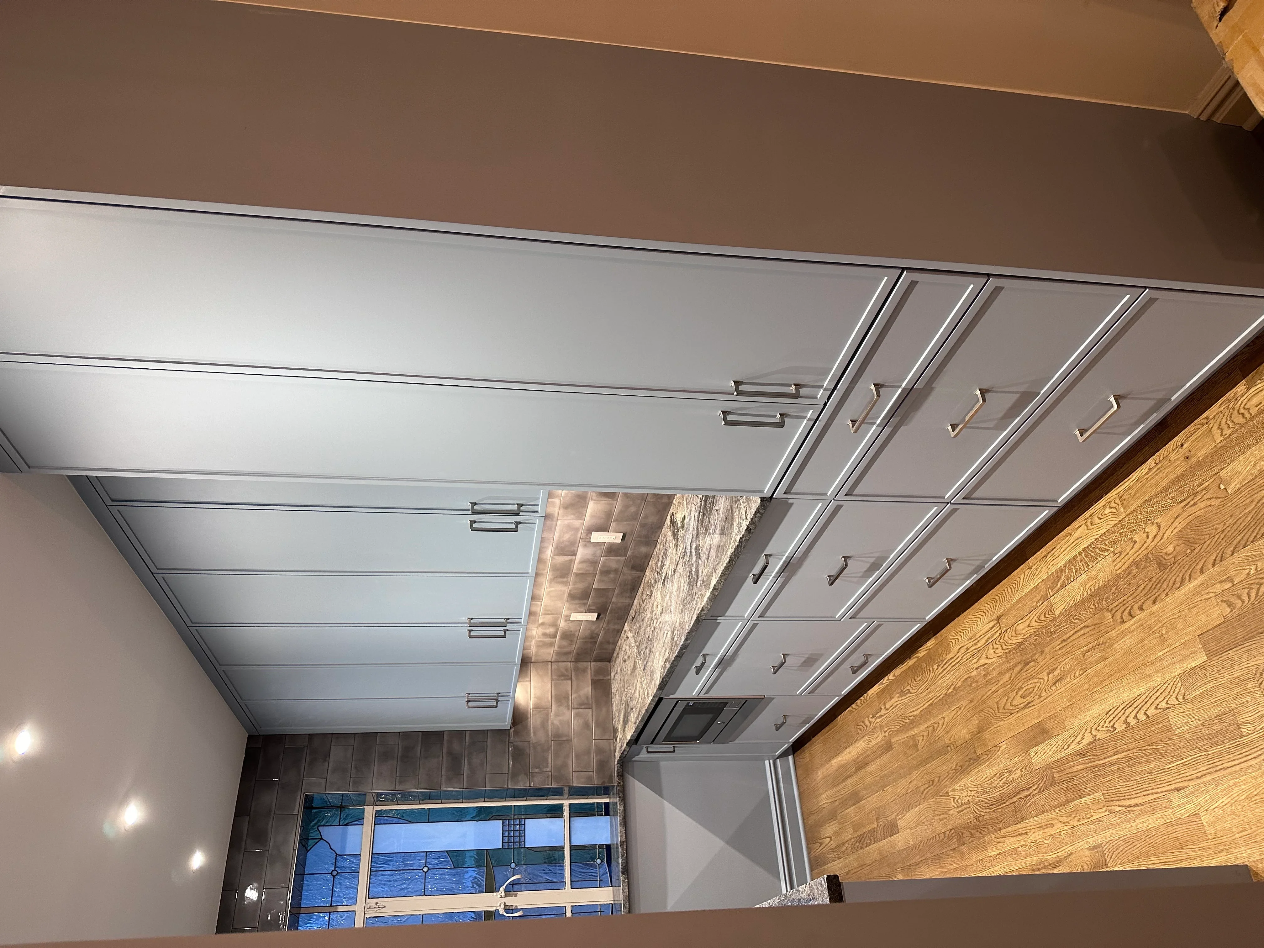 Modern suspended ceiling with recessed lights, drywall walls, and wood paneling in commercial space