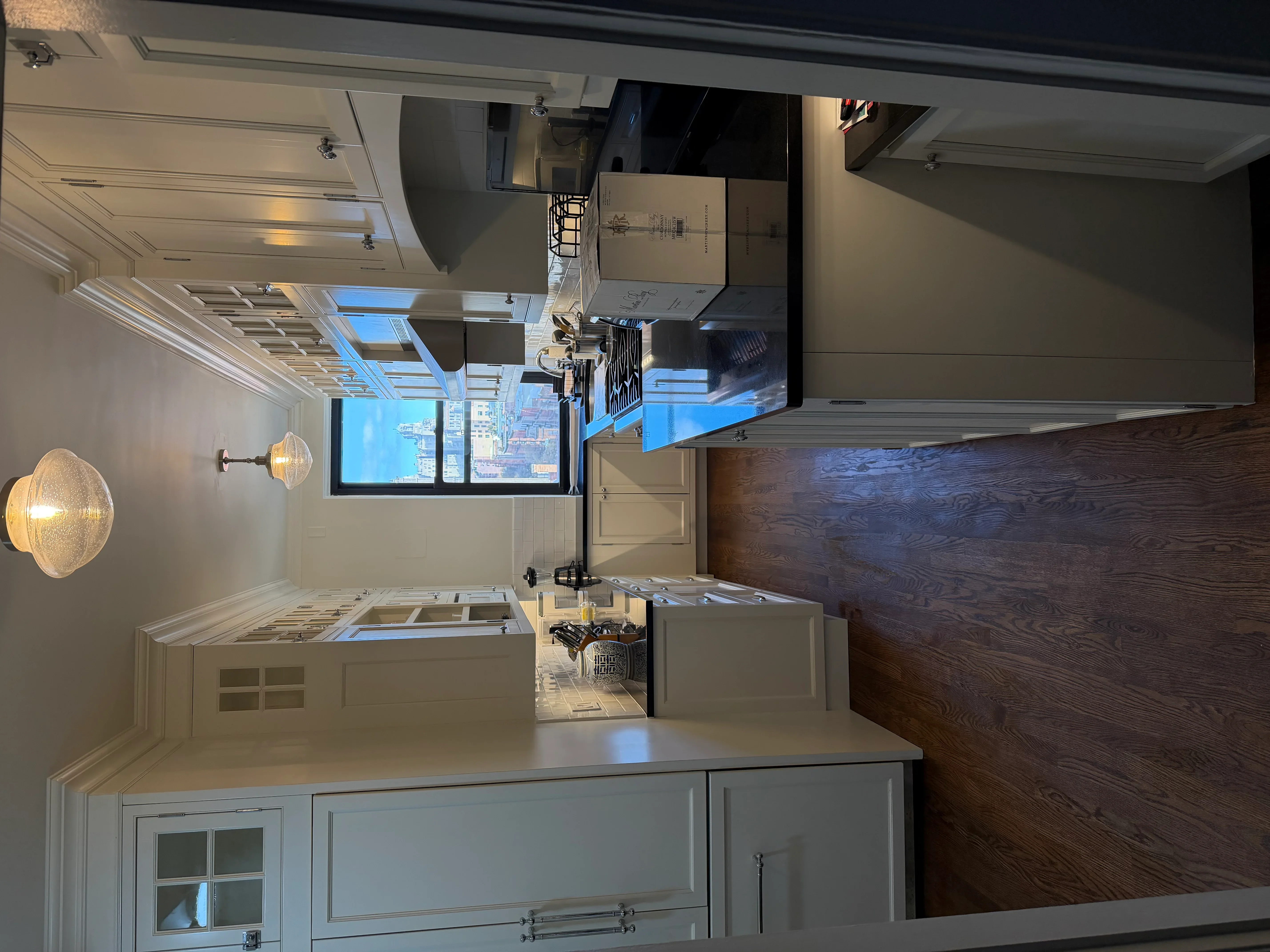 Modern kitchen with gray cabinetry, dark wood accent wall, and quartz countertops